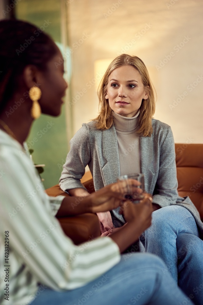 Two Women Having a Focused Conversation in a Comfortable Setting