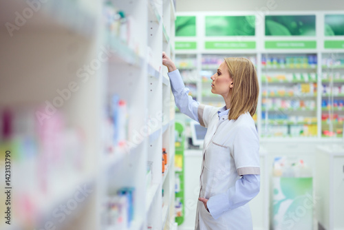 Free Download Pharmacist Organizing Medication in a Modern Pharmacy with Shelves of Health Products - GFXLoad