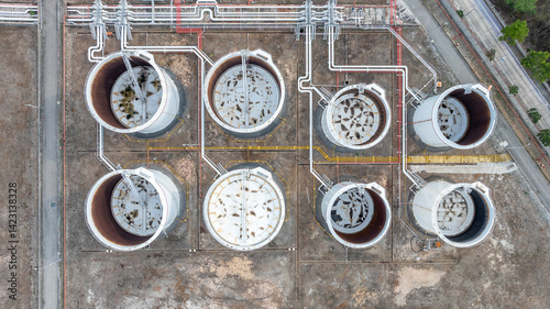 Obraz na płótnie Oil terminal industrial facility storage tank, Oil storage tank with oil terminal port loading arm cargo oil product tanker ship, Global business refinery industry commercial port. w salonie