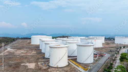 Obraz na płótnie Oil terminal industrial facility storage tank, Oil storage tank with oil terminal port loading arm cargo oil product tanker ship, Global business refinery industry commercial port. w salonie