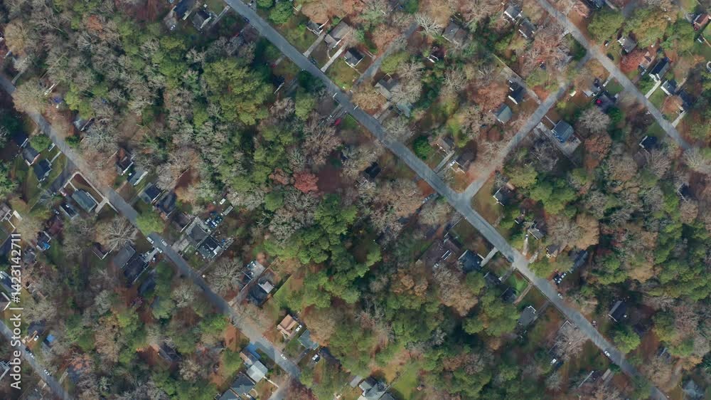 An overhead aerial tracking to the right diagonally across a scenic and historic Westside Atlanta, Georgia neighborhood, where a mix of working class people mix with new development and businesses.