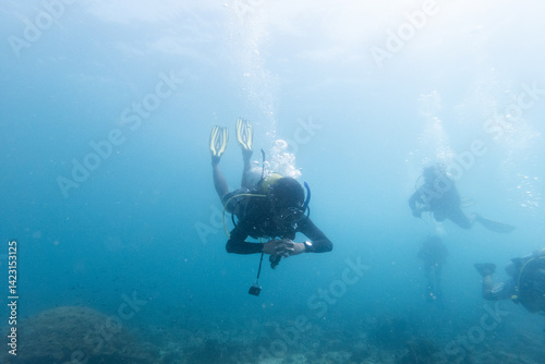 Scuba Divers Exploring Underwater World
