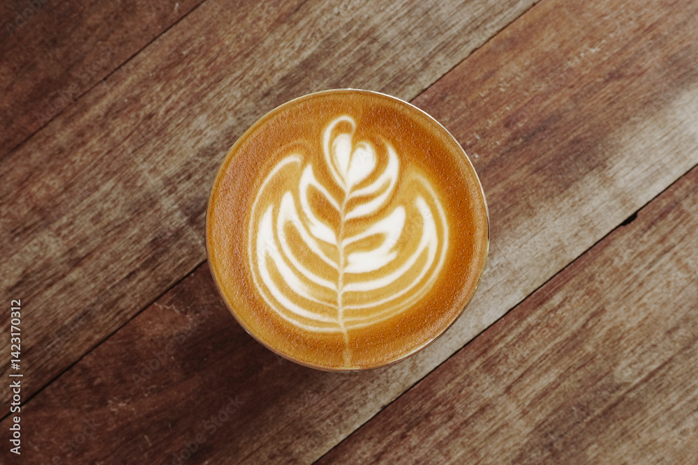 a cup of latte art coffee on wooden background a cup of latte art coffee on wooden background
