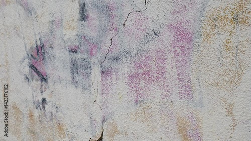 Old and grungy with peeling paintwall in destroyed building. Abandoned building. Cracked paint on concrete wall. moody and atmospheric. Old cracked wall surface showing wear over time. 4 k video