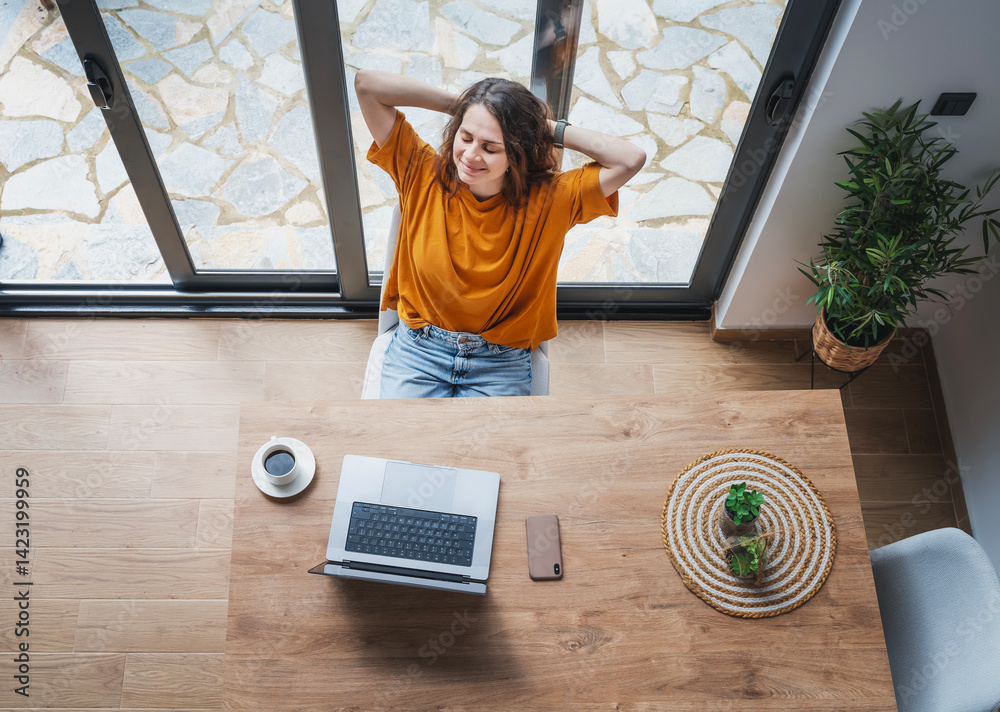 Creative young woman working on laptop in her studio