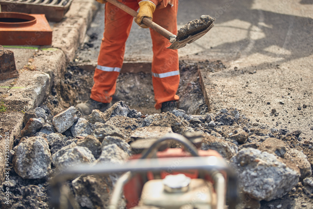 Construction worker working on a public city road reconstruction