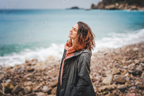 Obraz na płótnie Young relaxed woman enjoying sea breeze in rainy weather w salonie