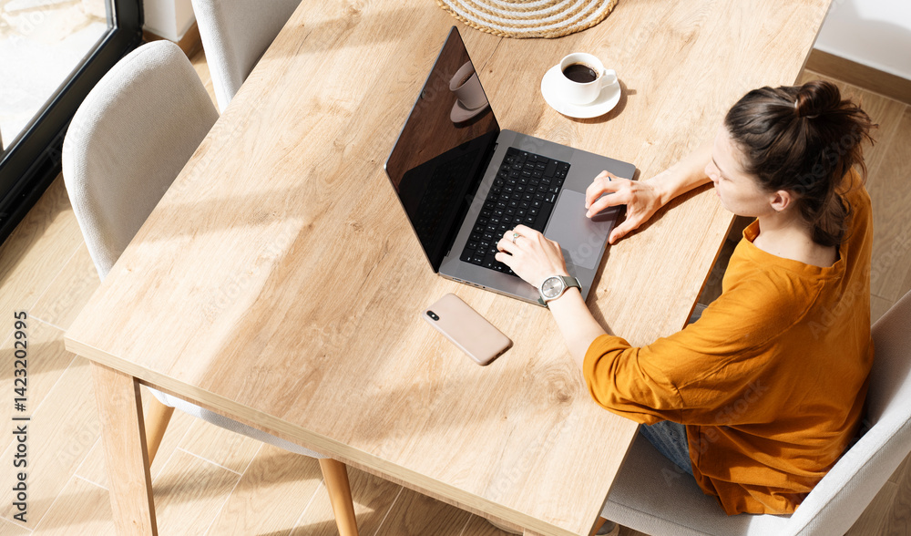 Working home concept Woman using a laptop computer for work at home top view.