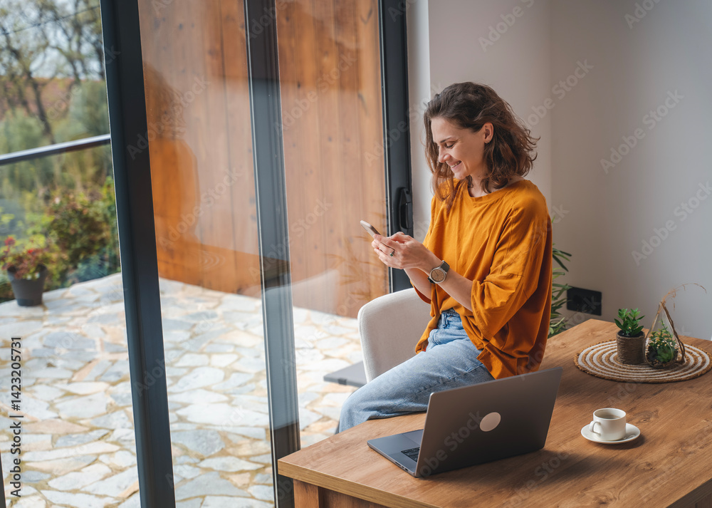 Creative young woman working on laptop in her studio
