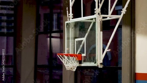 Basketball Swishing Through Indoor Hoop in Gymnasium
