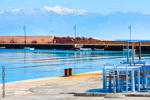 Obraz na płótnie Sea, cafe tables and snow mountains in Peloponnese, Greece w salonie