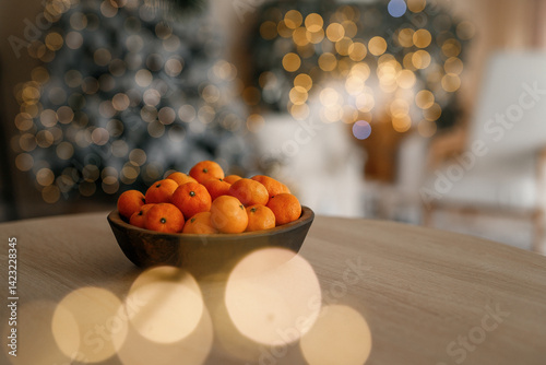 Fresh tangerines in a plate on a table with lights 