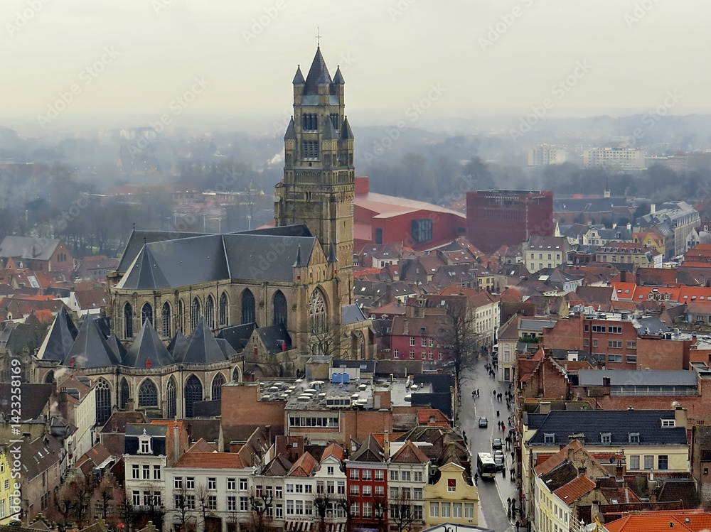 Obraz premium Bruges, Brugge, Belgium. Foggy Medieval Cityscape. Bruges cityscape, aerial panoramic view of Bruges historic city centre, old buildings tiled roofs and Saint Salvator s Cathedral