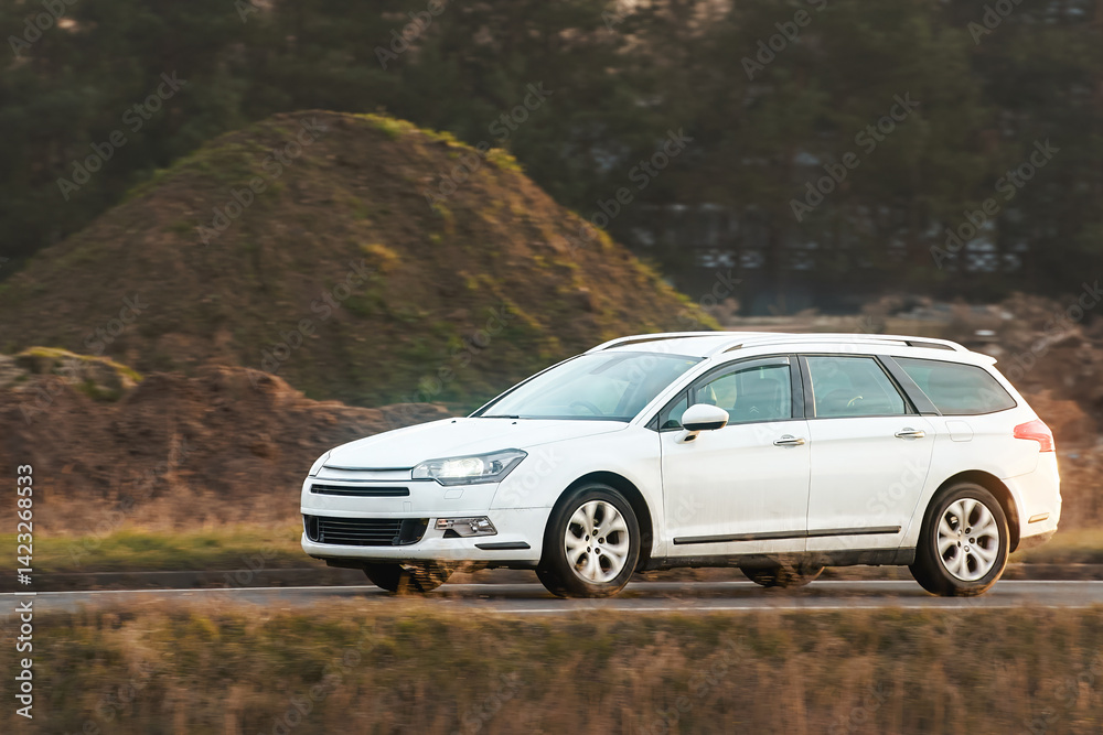 Family vehicle traveling green countryside