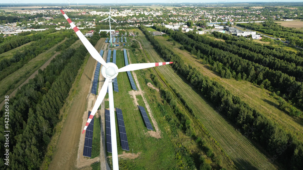 Aerial view of wind turbine and solar panels
