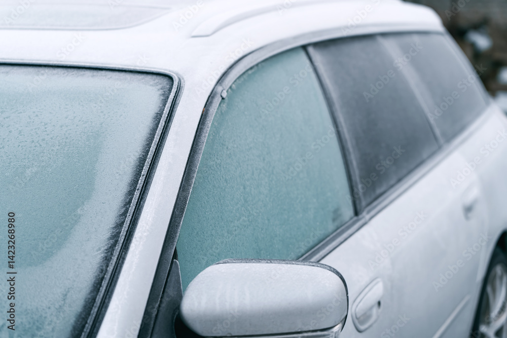 Frost-covered car parked in winter