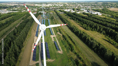Obraz na płótnie Aerial view of wind turbine and solar panels w salonie