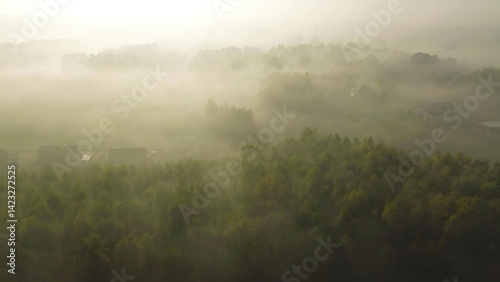 Obraz na płótnie Vibrant autumn fields and forest blanketed by morning fog w salonie