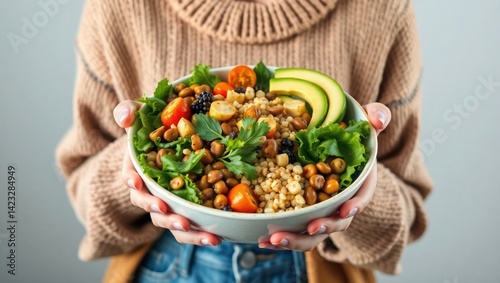 woman holding a bowl full of healty vegetables