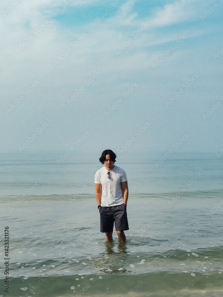 Man wears white t-shirt and sunglasses enjoy walking on the beach. Man wears white t-shirt and sunglasses enjoy walking on the beach.