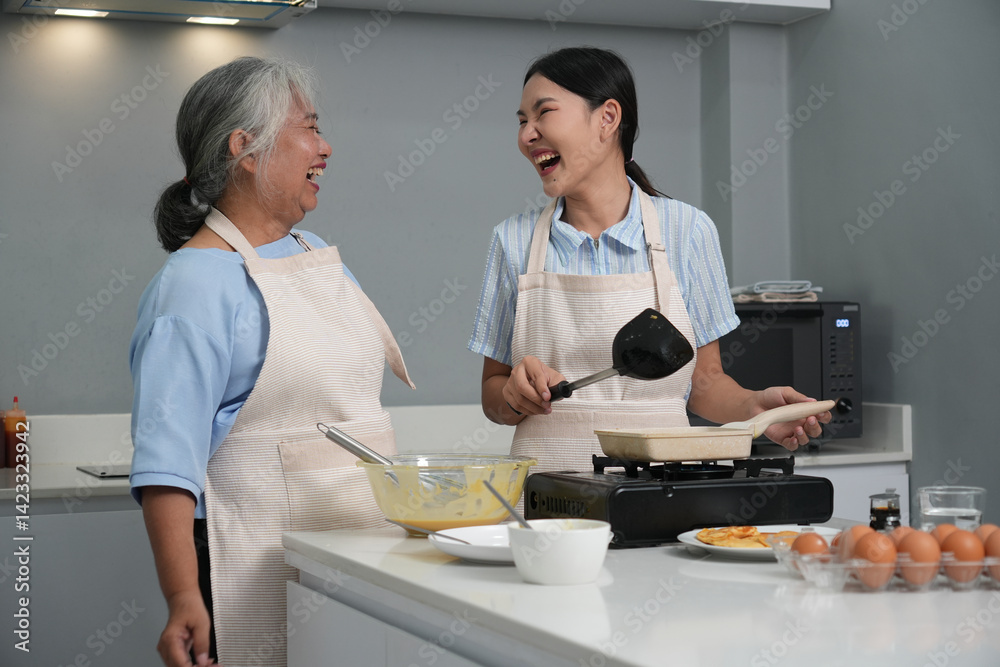 Two women, daughter cooking with elderly mother at home, happy mother's day, family day