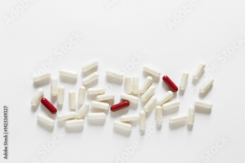 White, red and green capsules scattered on white background. different pills and tablets, medication pharmaceuticals health	
