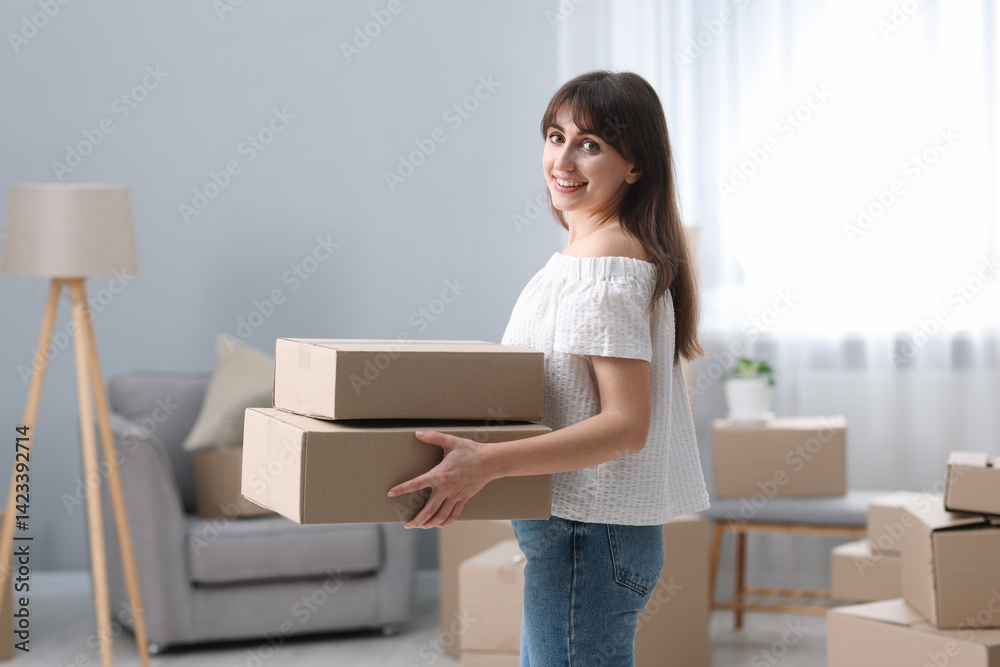 Moving day. Happy woman with cardboard boxes in her new home Moving day. Happy woman with cardboard boxes in her new home