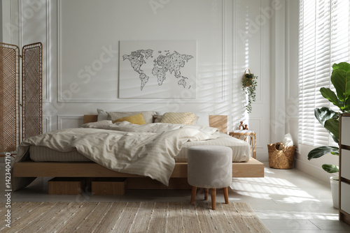 Comfortable bed with soft linens in stylish room. Interior design
