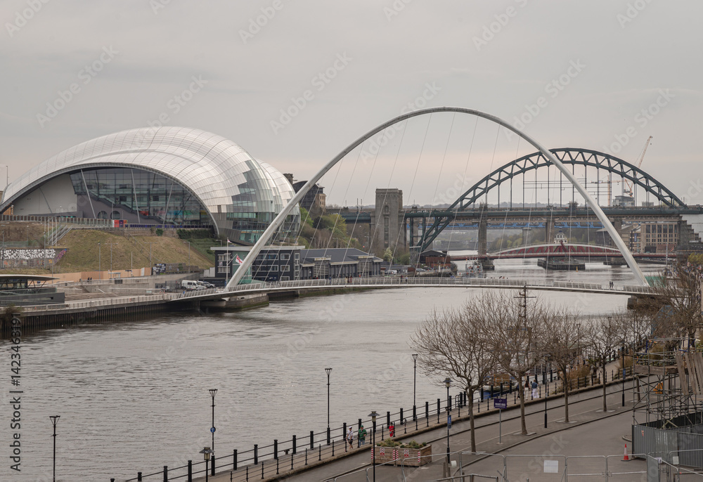 Stunning view of The Iconic gateshead millennium bridge spanning the River Tyne with Sage Gateshead and Tyne bridge in the background. use it as your Wallpaper, Poster and Space for text.