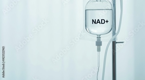 Close-up of NAD+ IV drip bag hanging against white background in medical setting