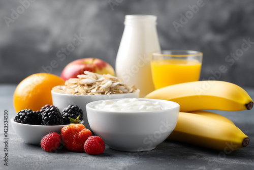 vibrant breakfast spread with whole grains, fruits, and dairy includes bananas, berries, yogurt, and orange juice, creating healthy and colorful meal