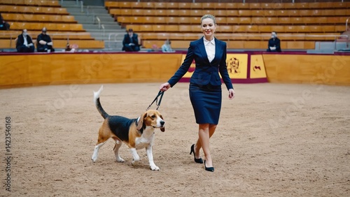 Obraz na płótnie A professional dog trainer in a business outfit, leading a service dog through an obedience demonstration. w salonie