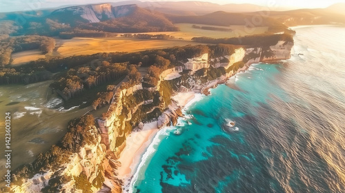 Aerial view of stunning coastline with cliffs and turquoise waters at sunset