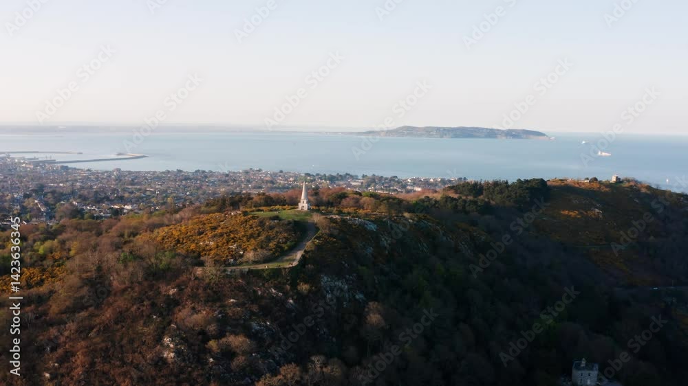 Aerial View of The Obelisk on Killiney Hill at Sunset with Dun Laoghaire Harbour and Howth in the Background Aerial View of The Obelisk on Killiney Hill at Sunset with Dun Laoghaire Harbour and Howth in the Background