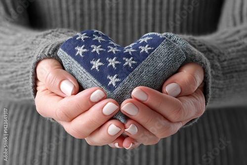 A folded American flag held in the hands of a grieving family member