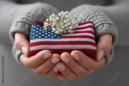A folded American flag held in the hands of a grieving family member