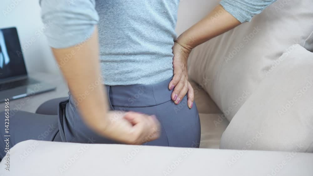 woman experiencing pain in the buttock and lower back from sciatic ...
