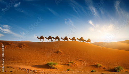 Camels walking in a row in a sandy desert in the sunset with big sand montains in the background scenery