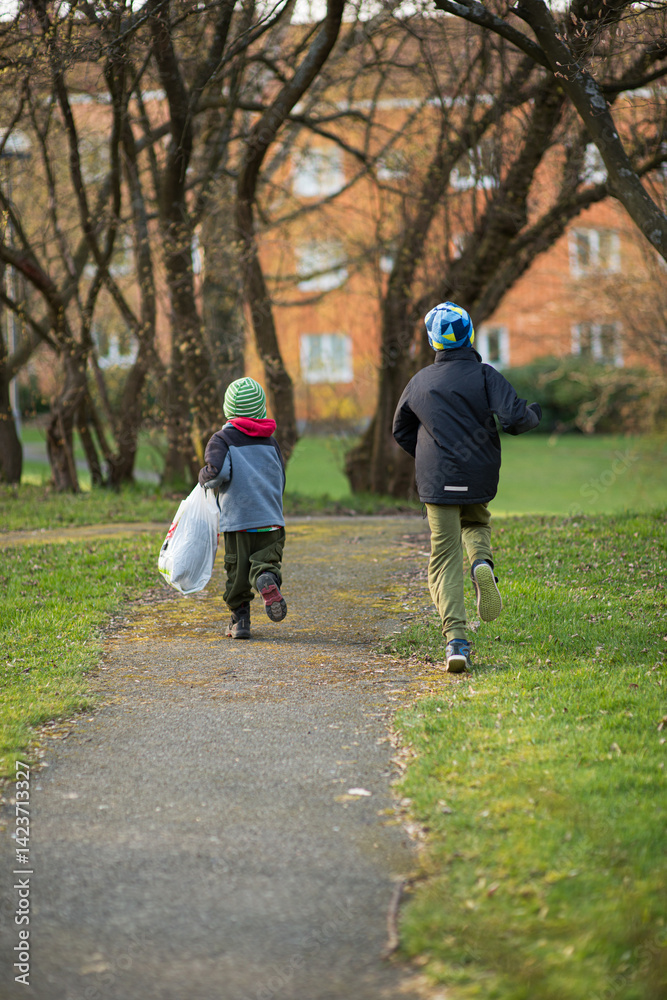 Fototapeta premium Children running on park pathway.