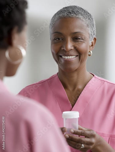 A kind caregiver gently assists a senior with medication, offering a reassuring smile - organizer thumb health wellness