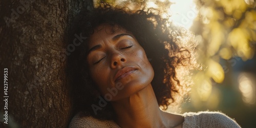Obraz na płótnie A serene moment captured in nature. A woman enjoys peace under a tree. Soft sunlight highlights her features. This image symbolizes tranquility and connection. AI w salonie