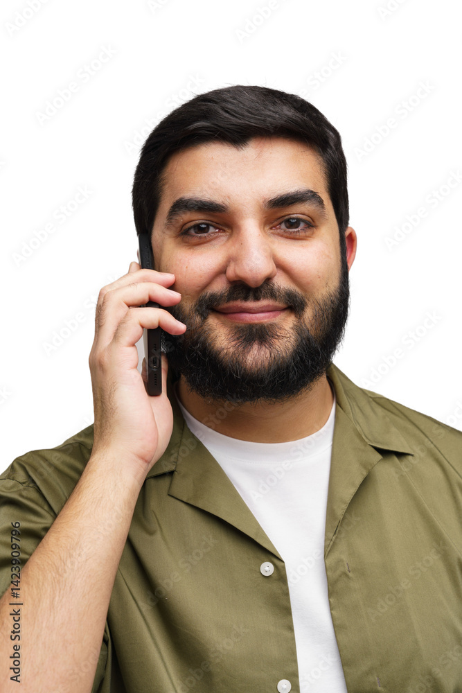 Man With Beard Engaging in a Phone Conversation While Wearing a Stylish Olive Shirt and a White Tee Man With Beard Engaging in a Phone Conversation While Wearing a Stylish Olive Shirt and a White Tee