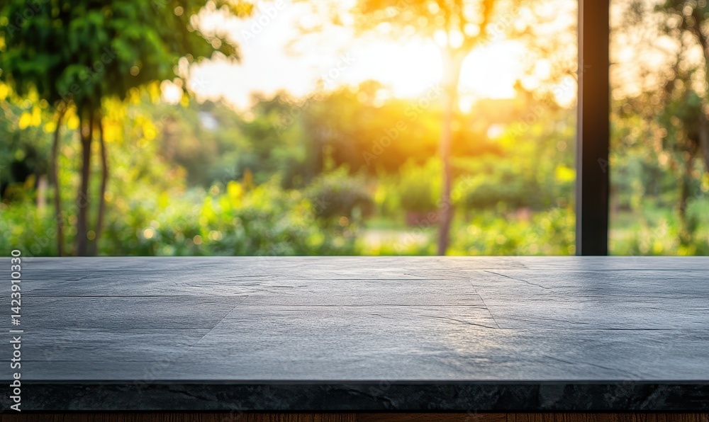 Empty dark gray stone countertop with blurred background of lush garden at sunset Empty dark gray stone countertop with blurred background of lush garden at sunset