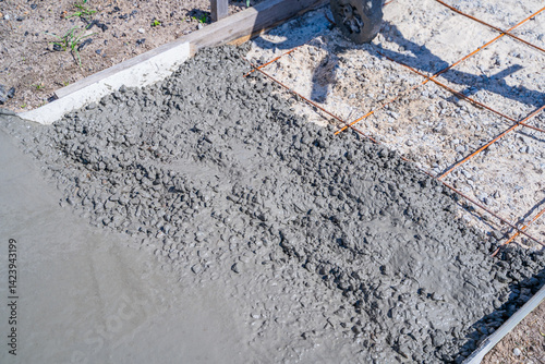 The process of pouring concrete on a path on a sunny day, close-up