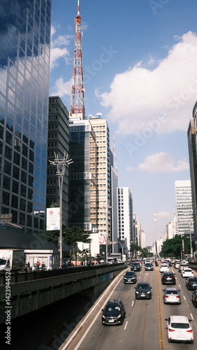 Wallpaper Mural Avenida Paulista street view with ongoing and incoming traffic, capturing the pulse of São Paulo's busiest and most iconic avenue in Brazil. Torontodigital.ca