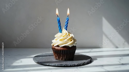 A cupcake with two candles