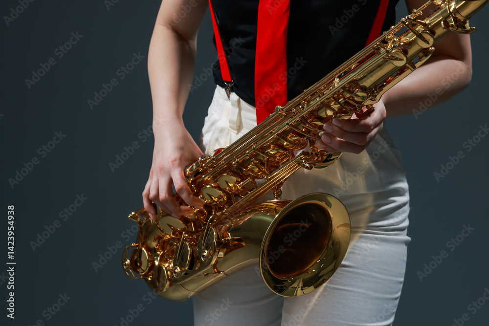 Naklejka premium Professional musician with saxophone on grey background, closeup
