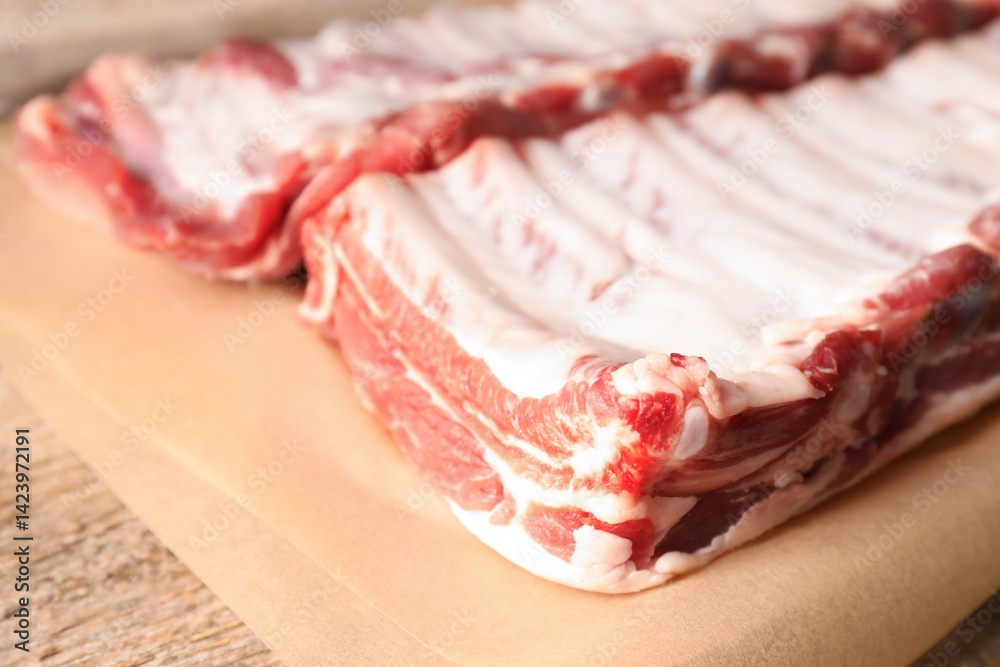 Raw pork ribs on wooden table, closeup