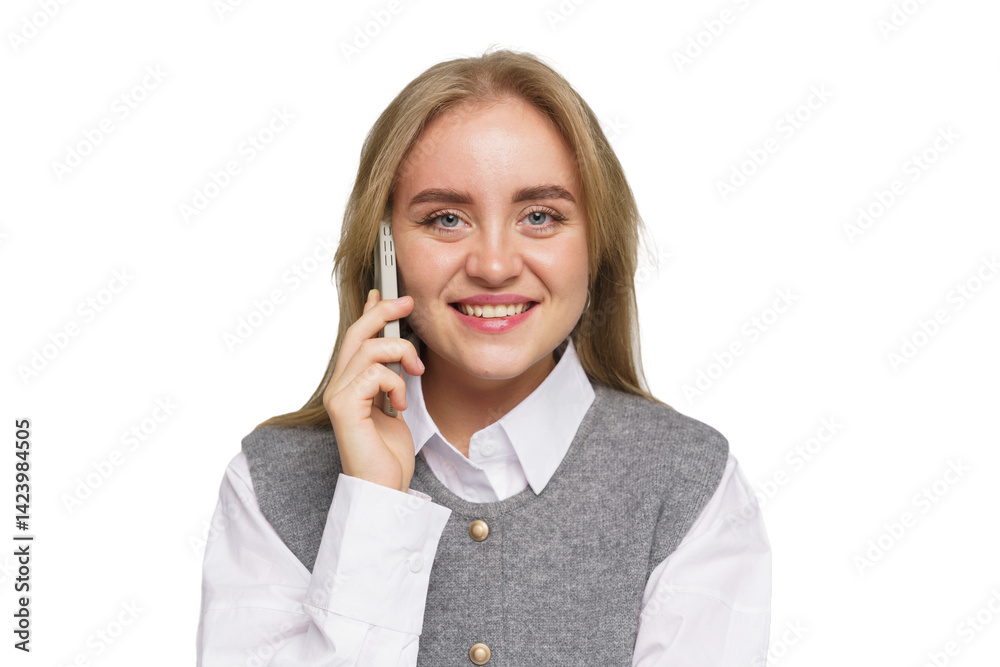 Smiling Young Woman in Casual Attire Happily Talking on the Phone While Standing Against a Plain Background Smiling Young Woman in Casual Attire Happily Talking on the Phone While Standing Against a Plain Background