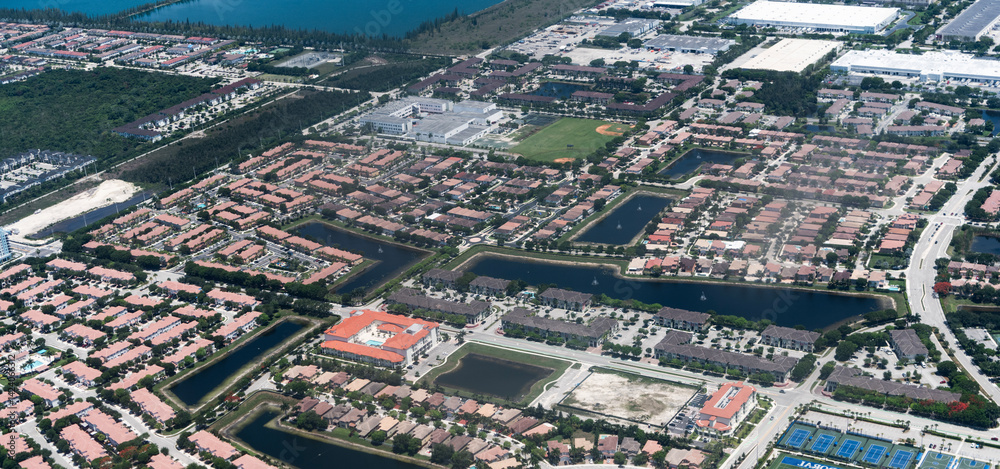 Fototapeta premium Suburban neighborhood top view. Township suburb. Aerial landscape. Landscape of residential neighborhood. Suburban neighborhood of town aerial view. Aerial neighborhood with house